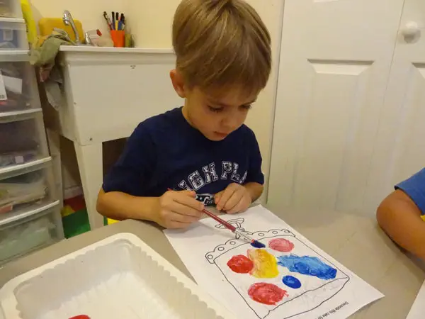 Child painting during an art activity at Diana Daycare A child painting a colourful picture during an art activity at Diana Daycare in Newmarket